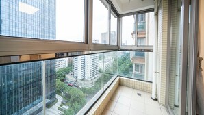 A high-rise apartment with large windows offering a city view. - Tyms Stylish 1BR APT  Yucui Garden (Shanghai)