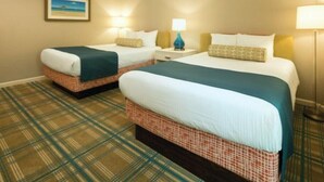 A hotel room with two beds, a checkered floor, and a framed picture on the wall. - 4th of July Near Disney (Lake Buena Vista)