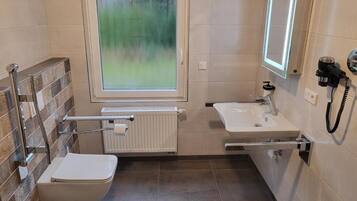 Shower, hair dryer, towels, toilet paper