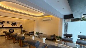 A modern lounge area with sofas, armchairs, and a coffee table. - Grand Museum Pyramids Hotel (Giza)