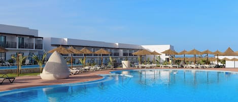 Outdoor pool, pool umbrellas, lifeguards on site