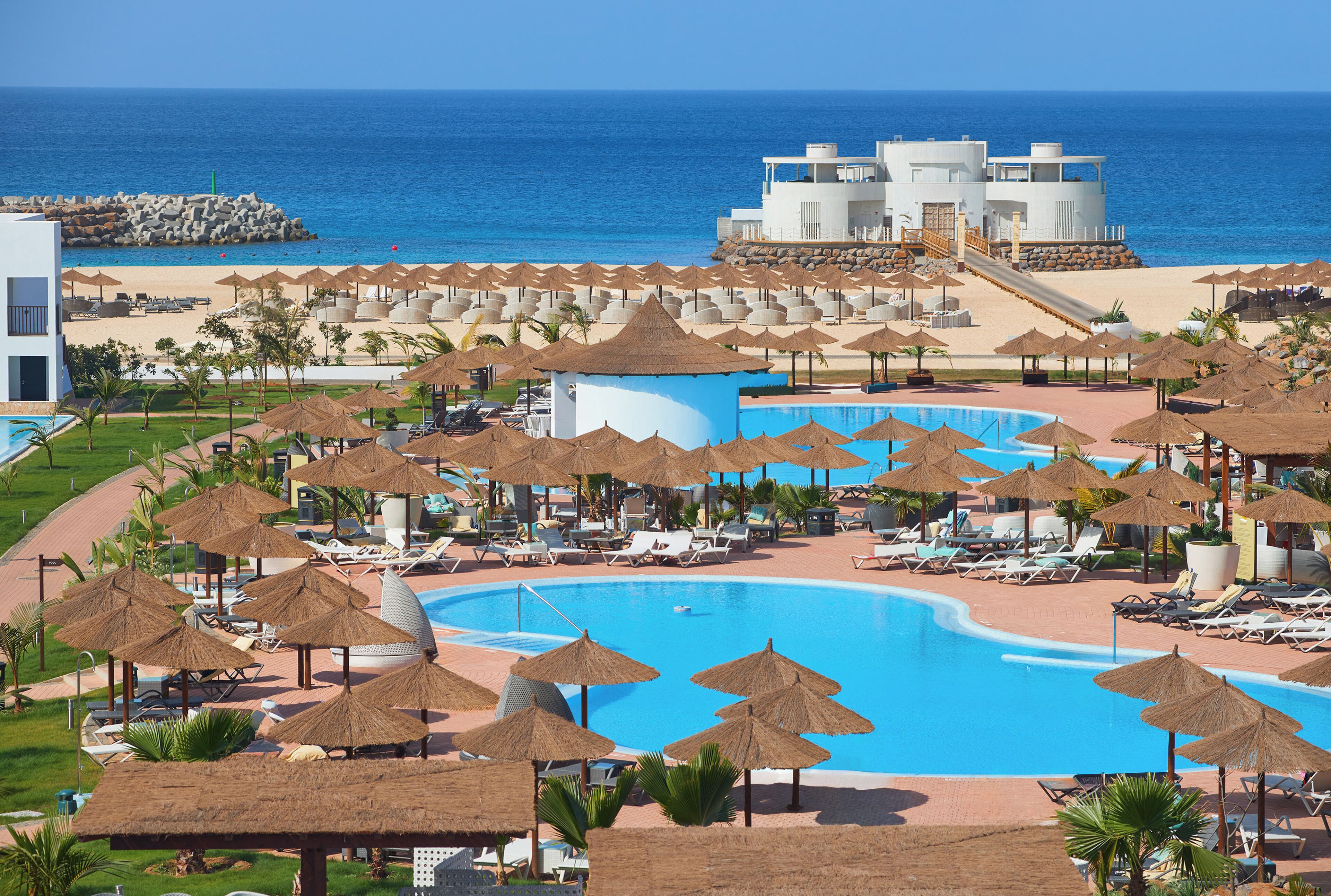 Outdoor pool, pool umbrellas, lifeguards on site