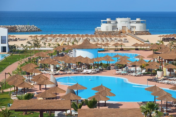 Outdoor pool, pool umbrellas, lifeguards on site