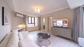 Superior Apartment, 1 Bedroom, Kitchen, City View | Living room | 55-inch Smart TV with cable channels