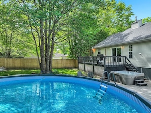 A backyard with a swimming pool, a hot tub, and a covered patio area. - Lake House: Hottub, Sauna, Firepit, Games! (Albrightsville)
