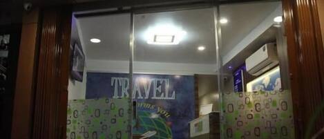 A travel agency with a prominent sign reading "TRAVEL" and a visible entrance.