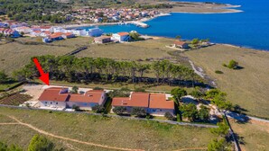 An aerial view of a coastal town with houses, a beach, and a clear blue sea. - Beachside Holiday Home Anamarija (Lozice)