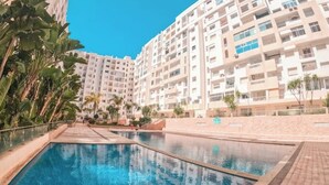 A swimming pool surrounded by high-rise residential buildings.