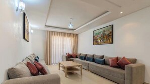 A modern living room with a beige sofa, a grey sofa, and a wooden coffee table. - Chic and contemporary, comfort guaranteed. (Agadir)