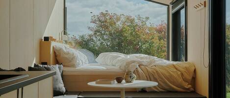 Raus | Cabins with field view + sauna access | Laptop workspace, blackout drapes, free WiFi, bed sheets