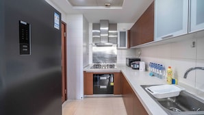 A modern kitchen with stainless steel appliances, a built-in oven, and a sink.