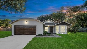 A single-story house with a garage, a front porch, and a well-maintained lawn.