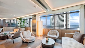A modern hotel lobby with a seating area, large windows, and a view of a high-rise building. - Brickell Arch Miami Pool & Free Parking (Miami)