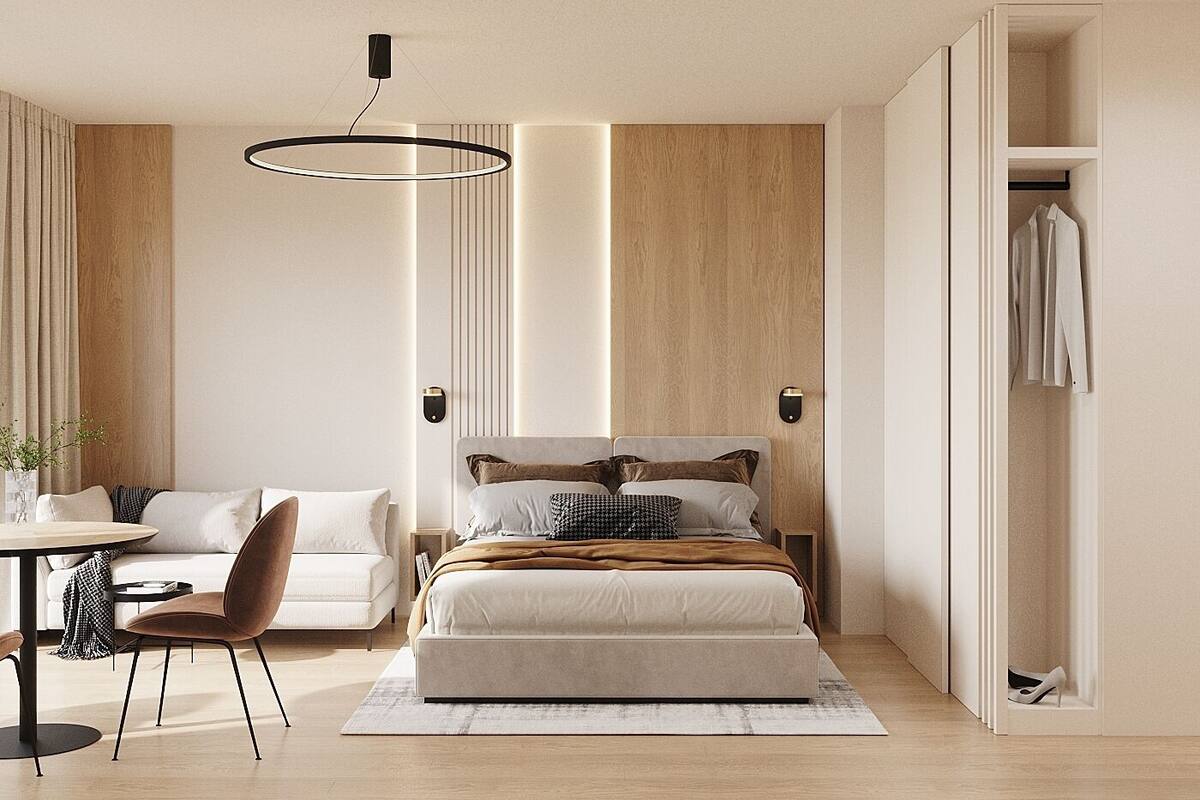 A modern bedroom with a bed, bedside tables, a desk, and a wardrobe.