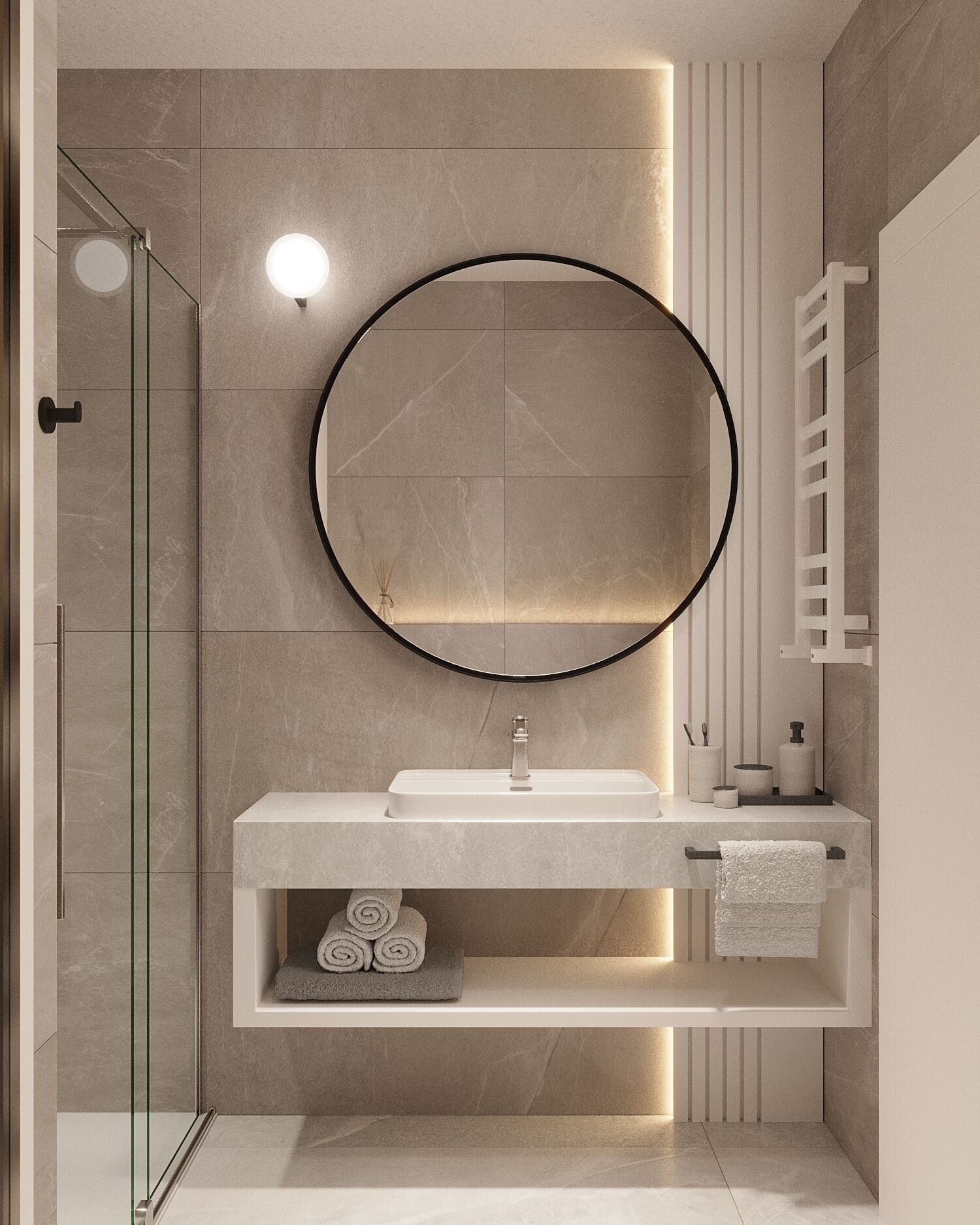 Un baño moderno con cabina de ducha de vidrio, un espejo redondo, un lavabo blanco y un perchero para toallas.