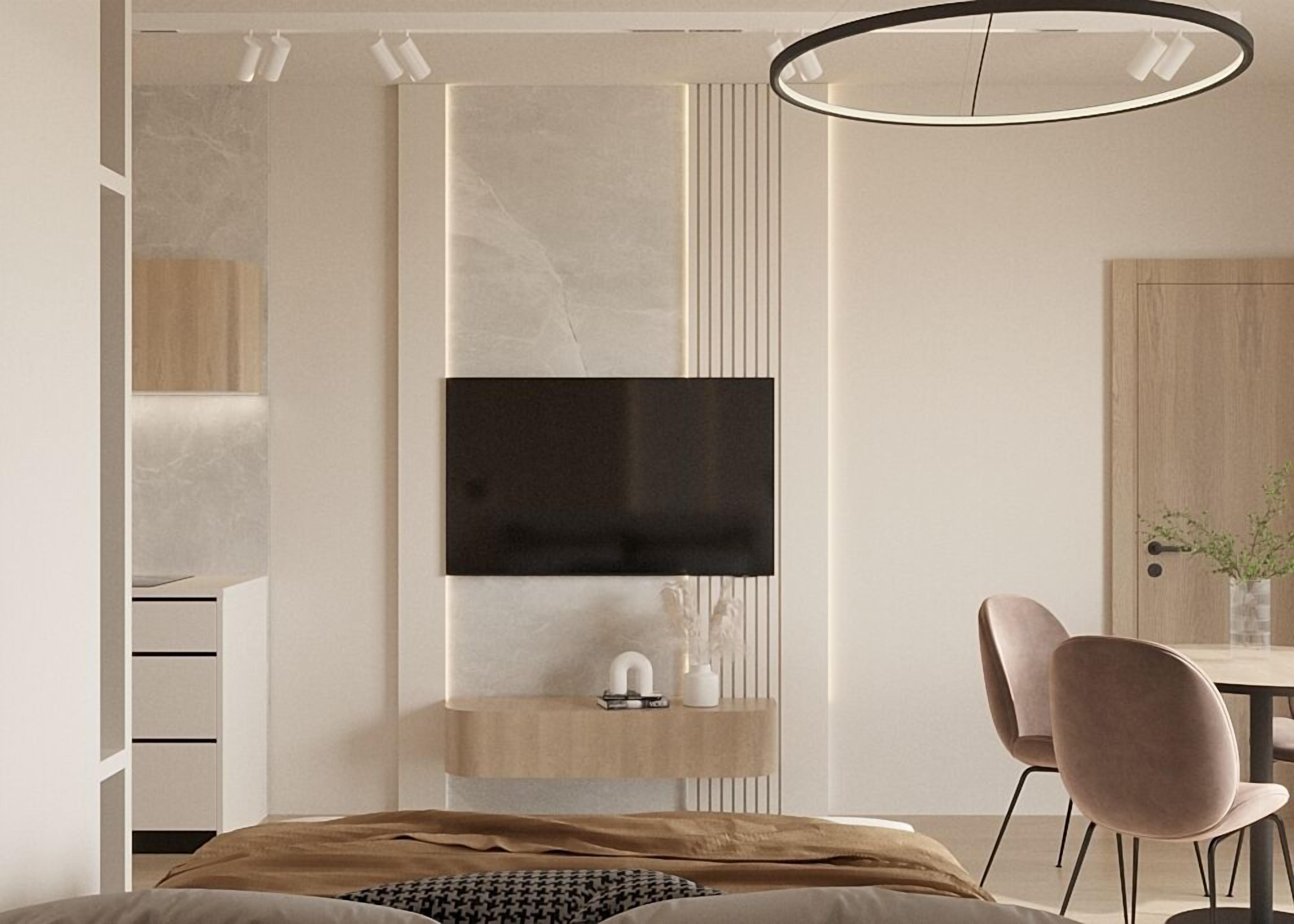 Un dormitorio moderno con una cama, un televisor montado en la pared, una mesita de noche y una silla.