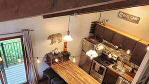 A modern kitchen with a wooden island, stainless steel appliances, and pendant lighting. - Cozy CB Condo Close to Ski Resort and Hiking/Biking (Crested Butte)