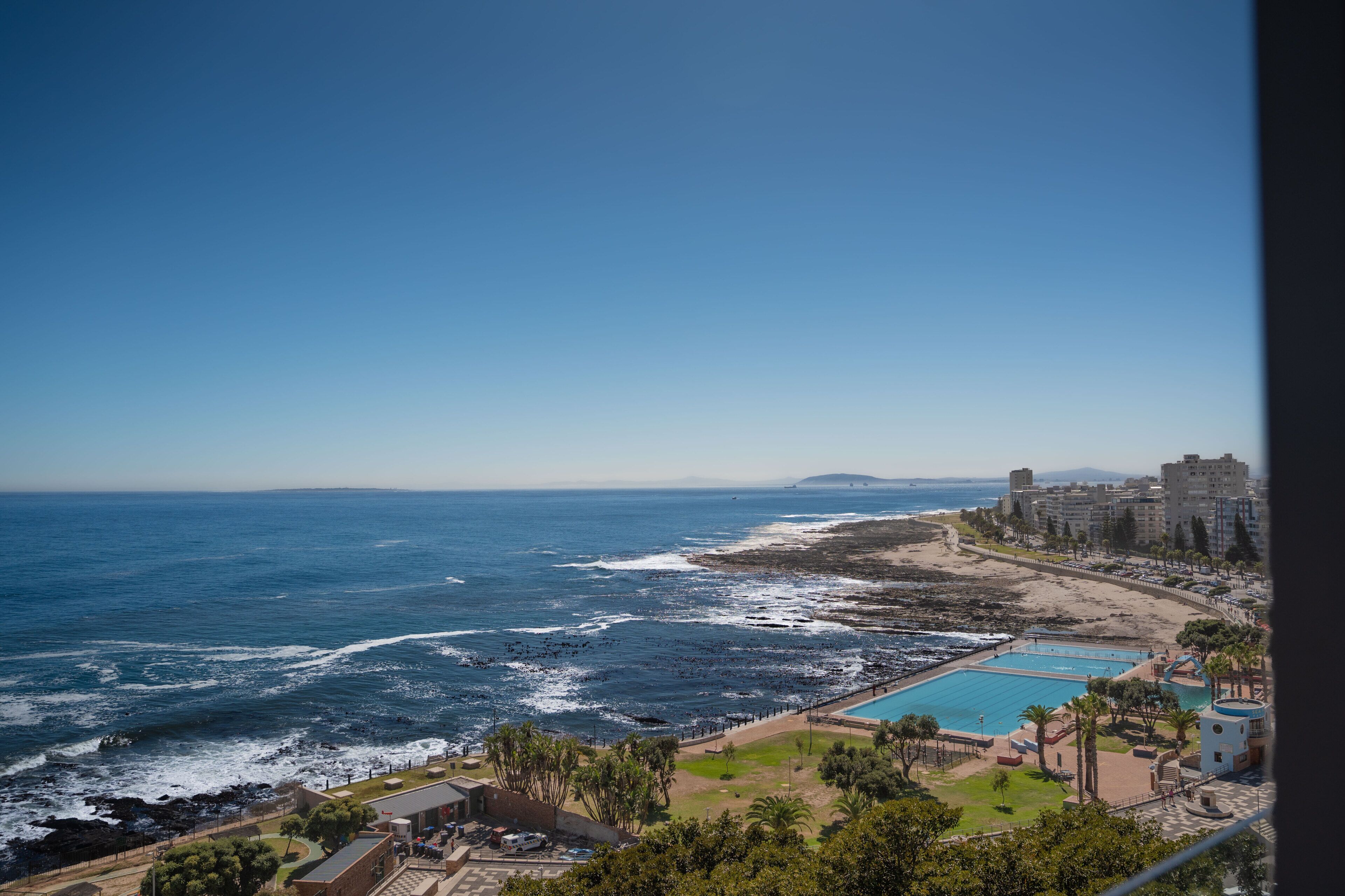 A coastal hotel with a pool, beach access, and ocean views.