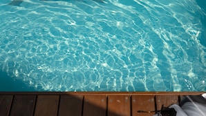 Een houten terras met een zonnebril en een tijdschrift.
