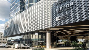 A modern building with a curved glass facade and a patterned exterior. - RentPlanet - Studio Zabrska (Katowice)