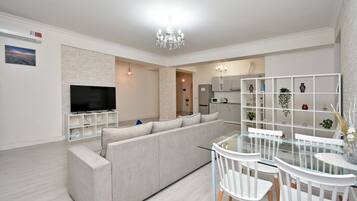 Deluxe Apartment, City View | Living area | 50-inch flat-screen TV with cable channels