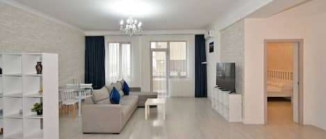 Deluxe Apartment, City View | Living area | 50-inch flat-screen TV with cable channels