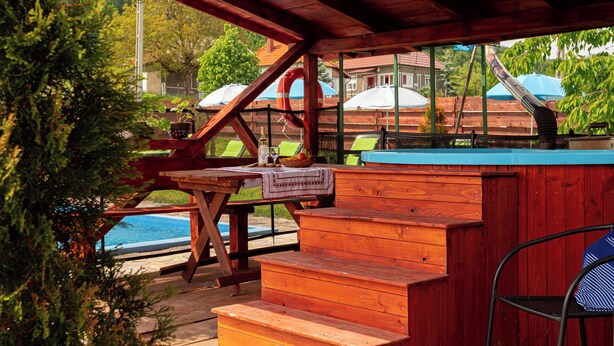 A wooden deck with a pool table, a bench, and a chair. - Transylvanian Home - Mountain View, BBQ & Pool (Bratca)