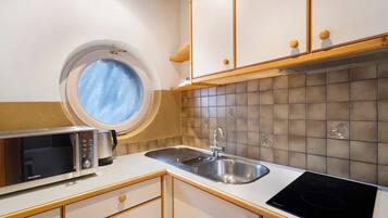 Een koelkast, een magnetron, een kookplaat, een vaatwasser