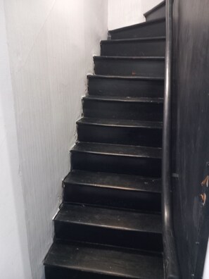 Een trap met een leuning aan de rechterkant.