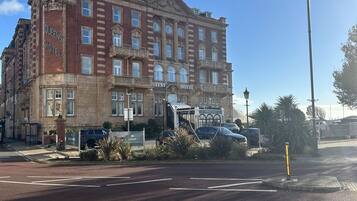 A large, historic hotel with a prominent corner entrance, multiple floors, and a classic architectural style.