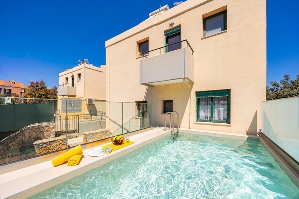 A modern building with a swimming pool, a stone wall, and a glass railing. - Villa Phedra - Three Bedroom Villa, Sleeps 6 (Kefalas)