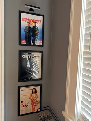 Three framed movie posters on a wall.