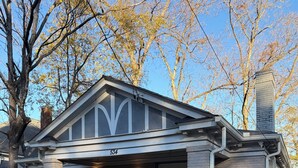 A two-story house with a front porch, a chimney, and a mailbox. - ATL Movie House, Theater Room, Sleeps9, Near Downtown (Atlanta)