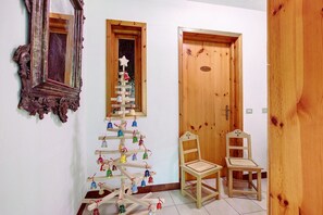 Una puerta de madera, un espejo y un adorno navideño.