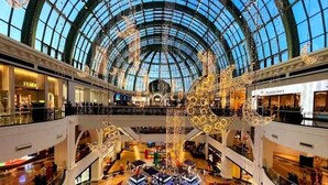 A spacious shopping mall with a large glass ceiling, multiple levels, and various retail stores. - Avari Al Barsha Apartment Hotel (Dubai)