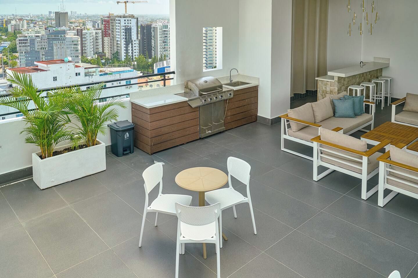 A modern living room with a balcony, a dining area, and a kitchen.