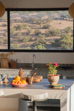 A kitchen with a view of a dry, hilly landscape. - 6-bedroom villa in amazing location with a wonderful view (Essaouira)