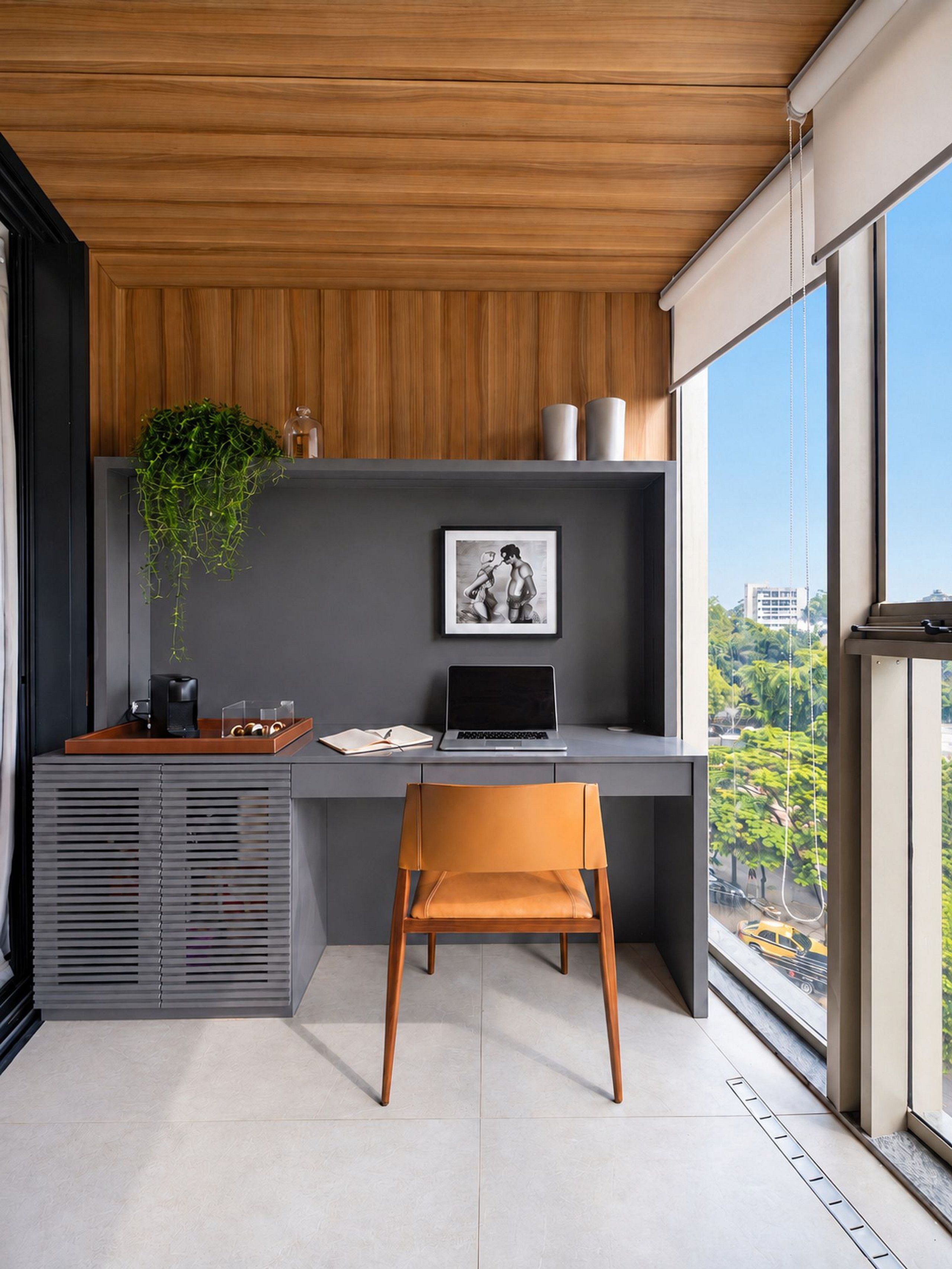 A modern office space with a desk, chair, and a view of the city through large windows.