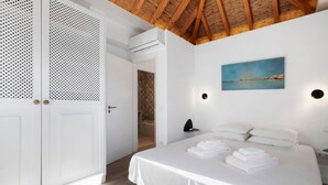 A hotel room with a bed, white curtains, a painting, and a shower area. - Villa - Canas da Ria - Private Pool (Santa Luzia)
