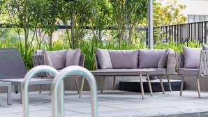 A poolside area with a sofa, chairs, and a table. - Hotel Waterloo Singapore - Handwritten Collection (Singapore)