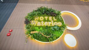 A hotel sign with 'HOTEL Waterloo' and a circular design with greenery. - Hotel Waterloo Singapore - Handwritten Collection (Singapore)