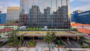 A modern hotel with a glass facade, a green roof, and a sign reading 'Hotel Waterloo.' - Hotel Waterloo Singapore - Handwritten Collection (Singapore)