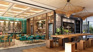 A modern interior with a bar area, seating, and a stone accent wall. - Kamaliss MontAzure Phuket - MGallery Collection (Kamala)