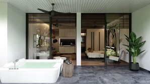 A modern spa area with a large white bathtub, a ceiling fan, and a potted plant. - Kamaliss MontAzure Phuket - MGallery Collection (Kamala)