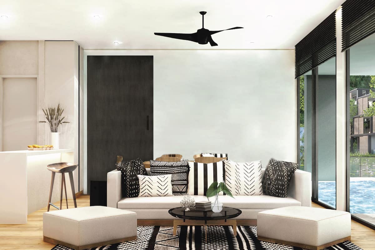 A modern living room with a sectional sofa, a coffee table, and a ceiling fan.