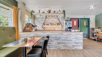 A restaurant with a stone counter, bar area, and seating.