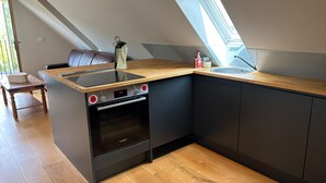 A modern kitchen with a built-in oven, a wooden countertop, and a skylight. - Tranquil Pond View Loft Retreat in Sudbury (Sudbury)
