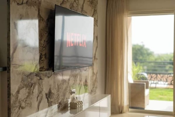 A television mounted on a wall with a marble pattern.