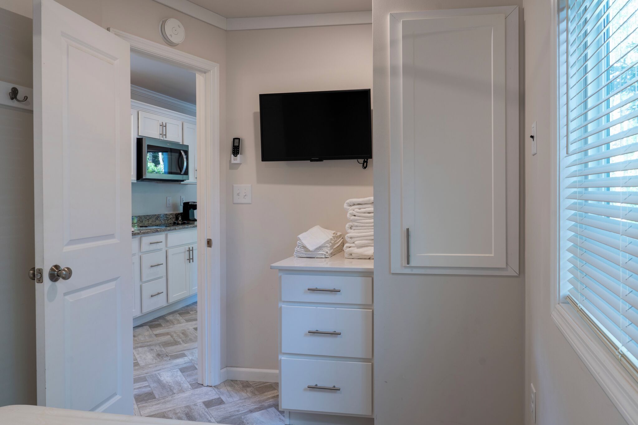 A bathroom with a toilet, sink, and a mirror.