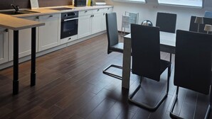 A modern kitchen with a dining area, skylights, and a view of greenery. - Vacation apartment "Hahnskamp" / 2-6 pers. - Vacation on the farm - (Hamminkeln)